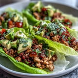 Low-carb Turkey Taco Lettuce Wraps pile high with fresh, vibrant toppings.