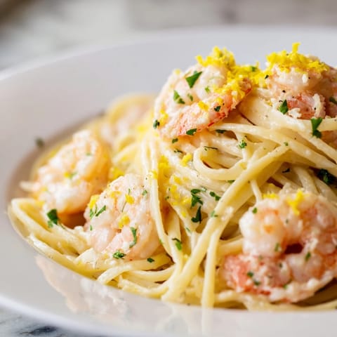 Heaped in a white bowl, this Garlic Butter Shrimp Linguine features plump, pink shrimp nestled against al dente pasta strands.