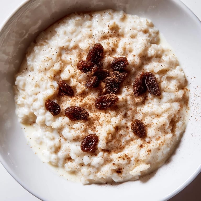 Warm, creamy rice pudding with a sprinkle of nutmeg, offering a comforting and delicious experience.