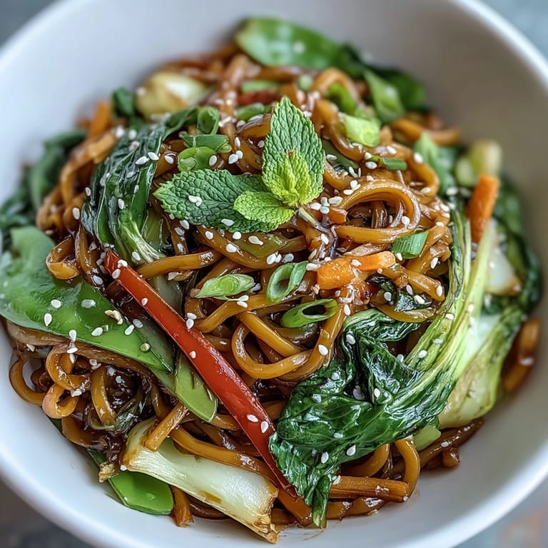 Fragrant ginger sauce glistens on Shirataki Noodle Bowl, garnished with green onions and sesame seeds.