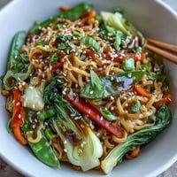 A close-up of a vibrant Shirataki Noodle Bowl filled with crisp bok choy and red bell pepper.